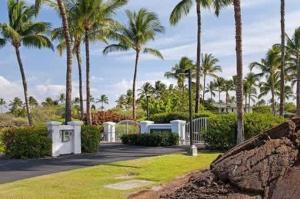 a park with palm trees and a fence and grass at Spacious retreat with pool & private lanai in Waikoloa +15 photos