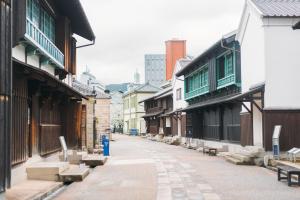 an empty street in an old town with buildings at GRAND BASE Saiwaimachi in Nagasaki