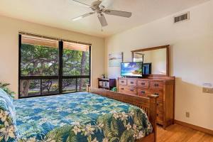 a bedroom with a bed and a dresser and a mirror at Tropical 1BR condo with pool & private lanai in Waikoloa +24 photos