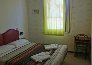 Postel nebo postele na pokoji v ubytování Hotel Ideale