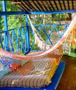 a hammock hanging from a blue pole at Casa Galeguita in Pipa
