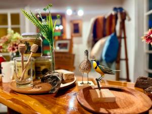 ein Holztisch mit Vogelfiguren darauf in der Unterkunft Hotel Geronimo in Pucón