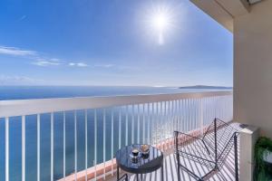 a balcony with a table and a view of the ocean at Luxury Top Floor Sea View Downtown Cap d'Ail in Cap d'Ail