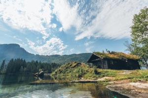 a house on the shore of a body of water at Strandbu in Viksdalen