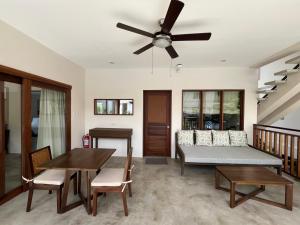 a living room with a couch and a ceiling fan at Ferra Resort Siargao in General Luna +72 photos