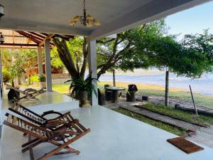 a porch with a bench and a view of the beach at Can win Resort Yala in Tissamaharama