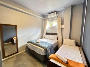 Ένα ή περισσότερα κρεβάτια σε δωμάτιο στο Pousada Recanto das Praias