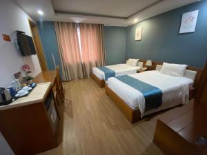 En eller flere senge i et værelse på New Merry Hotel And Spa + 2 billeder