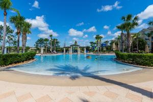 a swimming pool at a resort with palm trees at Private Pool Disney Townhome - Walk to Water Park in Orlando