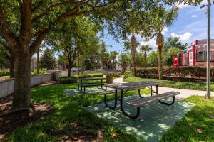 a picnic table and benches in a park at Private Pool Disney Townhome - Walk to Water Park in Orlando
