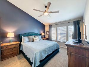 a bedroom with a bed and a ceiling fan at Private Pool Disney Townhome - Walk to Water Park in Orlando +50 photos