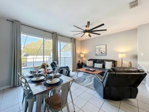 a living room with a table and a couch at Private Pool Disney Townhome - Walk to Water Park in Orlando
