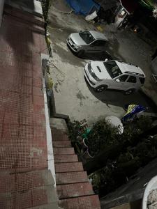 two cars are parked in a parking lot at Maitreya Homestay in Tawang +7 photos