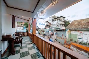 a balcony of a restaurant with a view of a city at Mia Bae Lodge in Coron