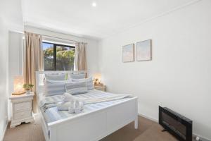 Giường trong phòng chung tại Apartment 5 Pacific Apartments