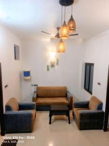 a living room with two couches and a table at The Dreams sea view in Puducherry