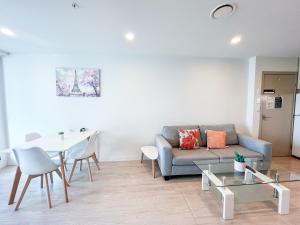 a living room with a couch and a table at Sky Tower Views 2BR Retreat Wit h FREE Pool Gym in Auckland