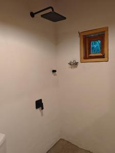 a room with a ceiling fan and a window at Casa Momo Playa Zipolite Oaxaca in Zipolite +19 photos