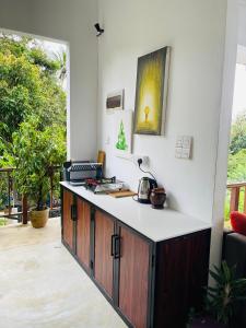a kitchen with a counter and a counter top at Hiriketiya Ladina Homestay in Dickwella +20 photos