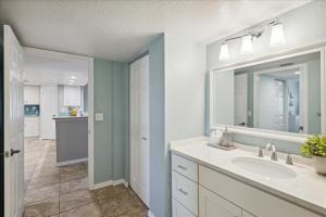 a bathroom with a sink and a mirror at Shorewood 401 in Cape Canaveral +41 photos