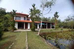 a house with a pond in front of it at Samaya Waters Bentota in Haburugala