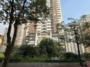 a tall building in a city with trees and buildings at Phương Đông 502DT in Hanoi