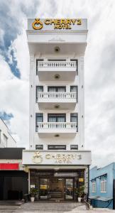 a white building with a chrysler sign on it at Cherry Hotel 2 Da Lat in Da Lat