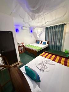 Ένα ή περισσότερα κρεβάτια σε δωμάτιο στο Sigiriya Luminary Homestay