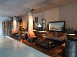 
a living room filled with furniture and a tv at Bisma Eight - CHSE Certified in Ubud
