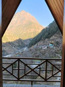 a view of a mountain from a window at The Clifton chapter tirthan in Gushaini