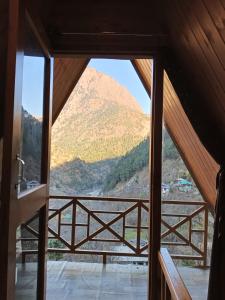 a view from a room with a view of a mountain at The Clifton chapter tirthan in Gushaini