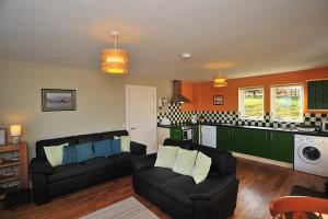 a living room with two couches and a kitchen at Beinn Edra apartment in Staffin