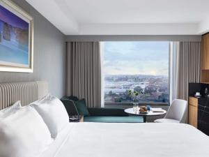 a hotel room with a bed and a large window at Mantra Melbourne Airport in Melbourne +112 photos