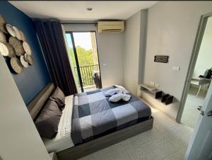 a small bedroom with a bed with a window at Z cape 1 two two in Ban Thalat Choeng Thale +45 photos
