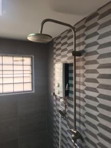 a shower in a bathroom with a black and white wall at Nordic Residences in Malacca +8 photos