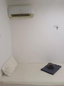 een bed met een handdoek en een rol papier bij Nordic Residences in Melaka