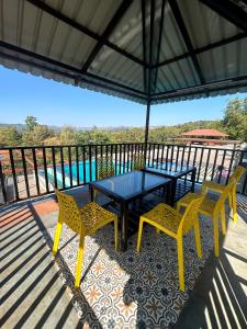 a patio with a table and chairs on a deck at Vandhaara Luxury Stays in Pune