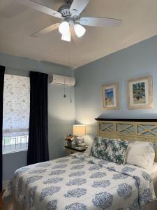 a bedroom with a bed with a ceiling fan at BellaDonna By The Bay in Bridgetown