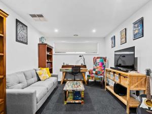 een woonkamer met een bank en een tv bij Tenang Escape Yarrawonga in Yarrawonga +12 foto's