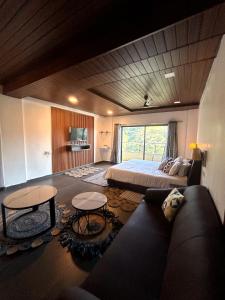 a large room with a bed and a couch at Vandhaara Luxury Stays in Pune