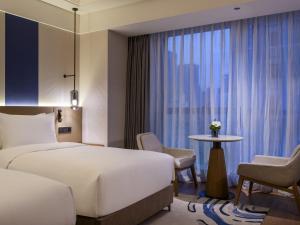 Ένα ή περισσότερα κρεβάτια σε δωμάτιο στο Novotel Shanghai JingAn +63 φωτογραφίες