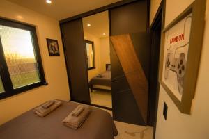 een kleine slaapkamer met een bed en een spiegel bij House California 