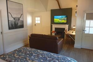 a bedroom with a bed and a couch and a television at Scenic Marysville in Marysville