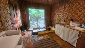a kitchen with a sink and a window in a room at Molmol Cafe in Larena