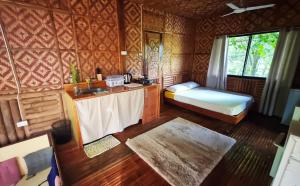 a bathroom with a sink and a bed in a room at Molmol Cafe in Larena +21 photos