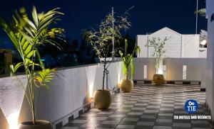 a row of potted plants on a balcony at night at Le Poshe Luxury - TIE in Puducherry