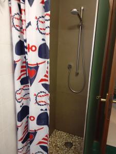 a shower curtain in a bathroom with a shower head at Carinissimo vicino a Venezia in Jesolo