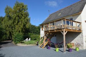 a house with a deck on the side of it at Moulin de la Fosse Soucy in Maisons