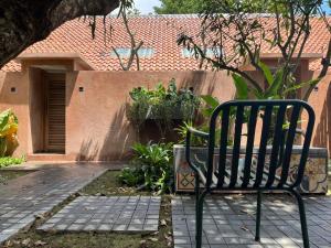 a bench sitting in front of a house at Komoreya Guesthouse in Yogyakarta