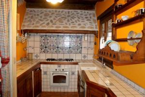 a kitchen with yellow walls and a stove top oven at Nonno Domenico in Sassano